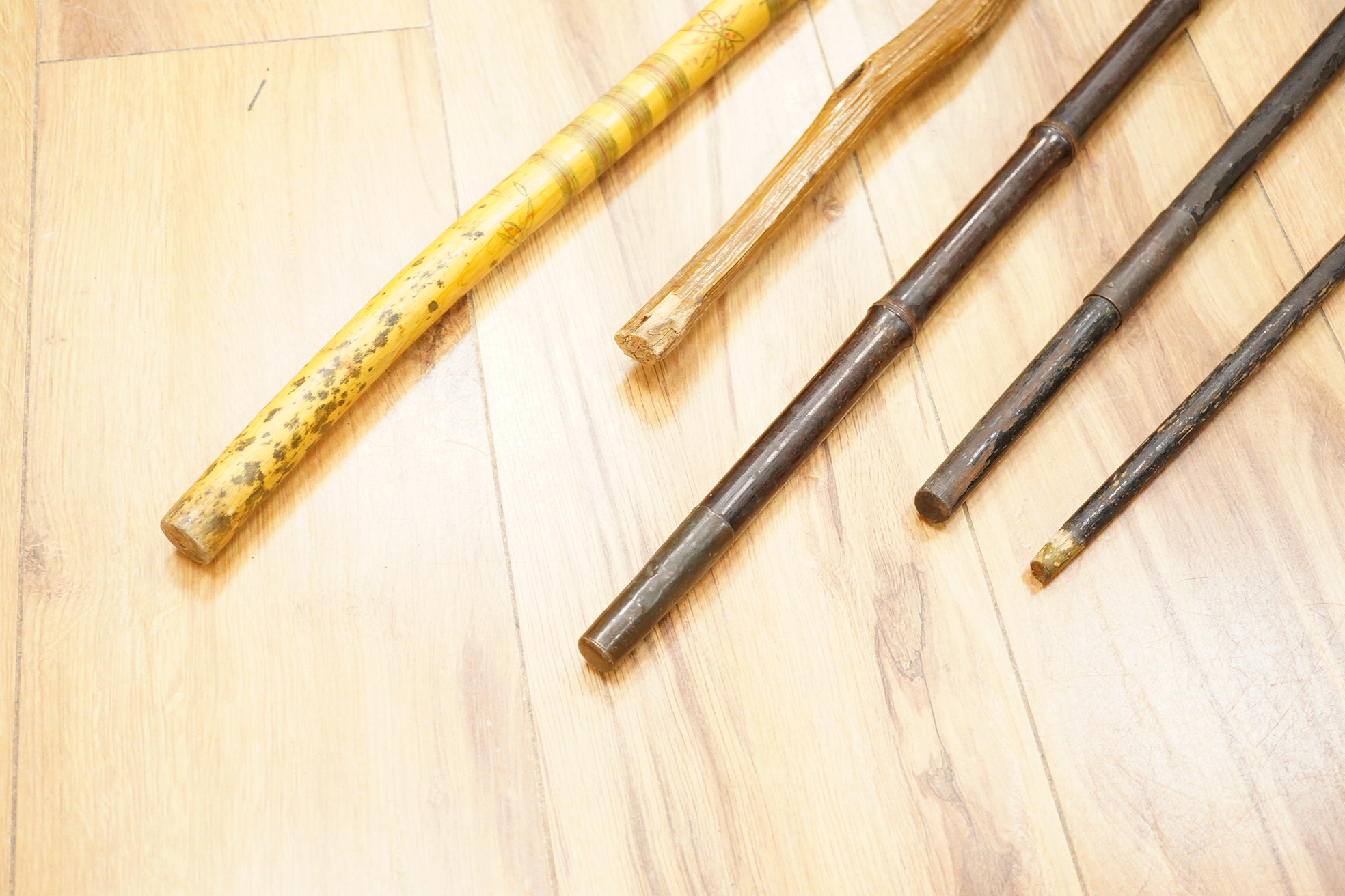 Five walking sticks including horn and a silver topped walking sticks and a carved topped walking stick with concealed chamber containing a metal tube - 93cm long. (5).